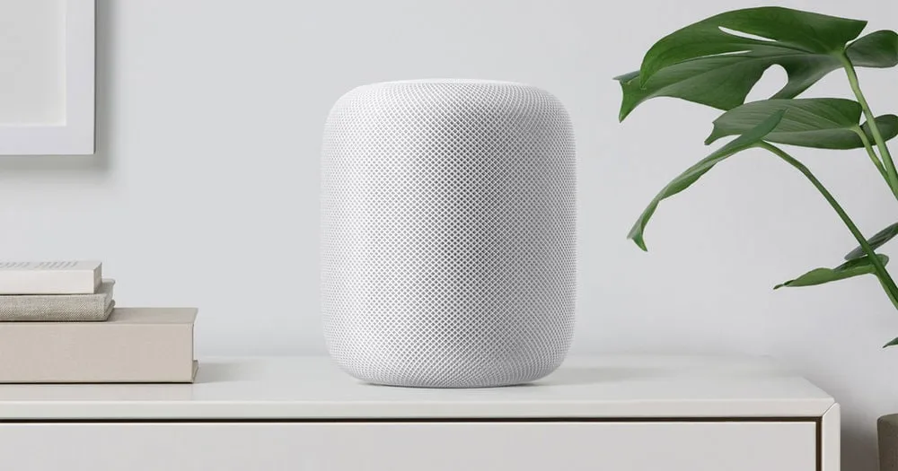 An Apple HomePod smart speaker on a shelf